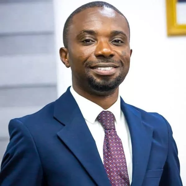 Ghanaian cocoa farmer tending to cocoa pods.
