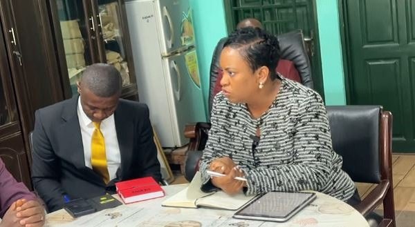 Police officer addressing students at a school assembly in Ghana
