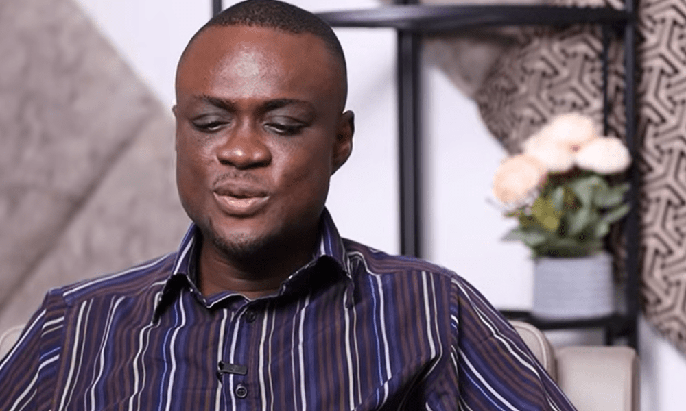 Selasi Sikanku smiling and speaking at an event.