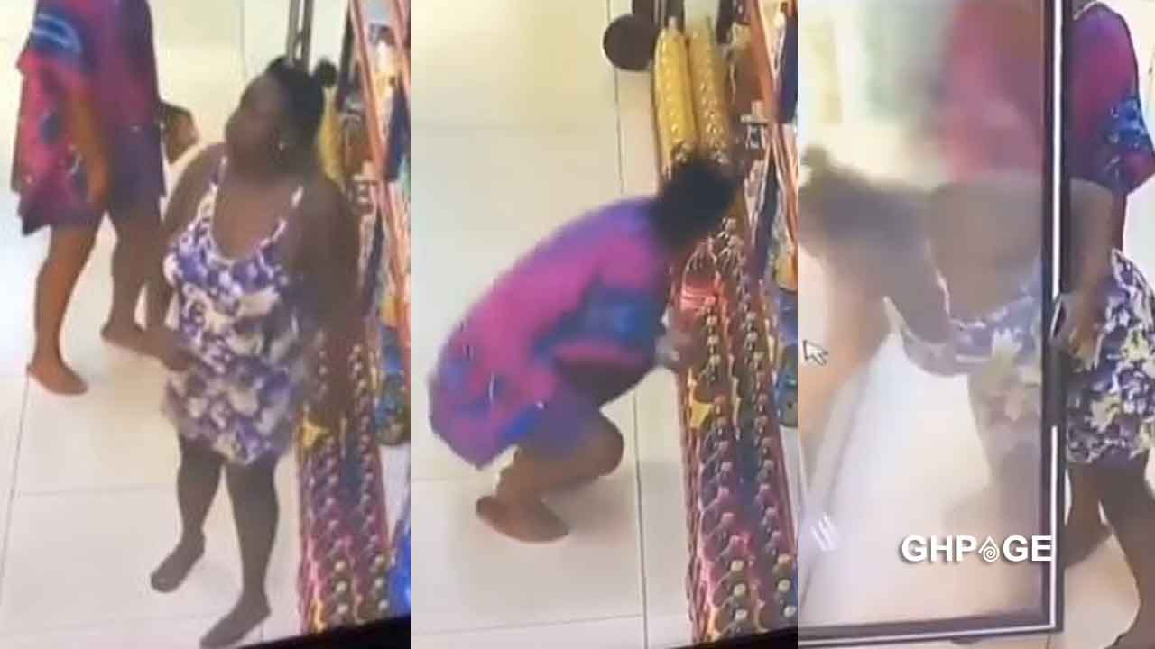CCTV footage showing two individuals discreetly shoplifting items in a supermarket aisle.