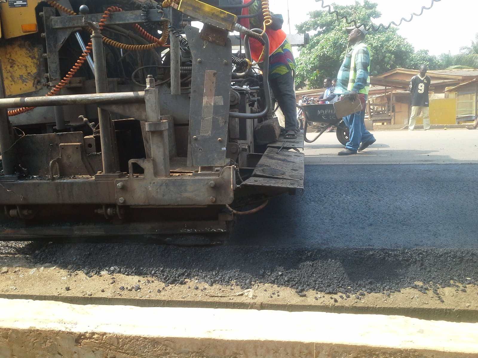 A wide shot of a major road construction project in Ghana with heavy machinery