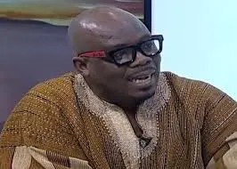 A close-up of a fuel pump nozzle at a Ghanaian petrol station