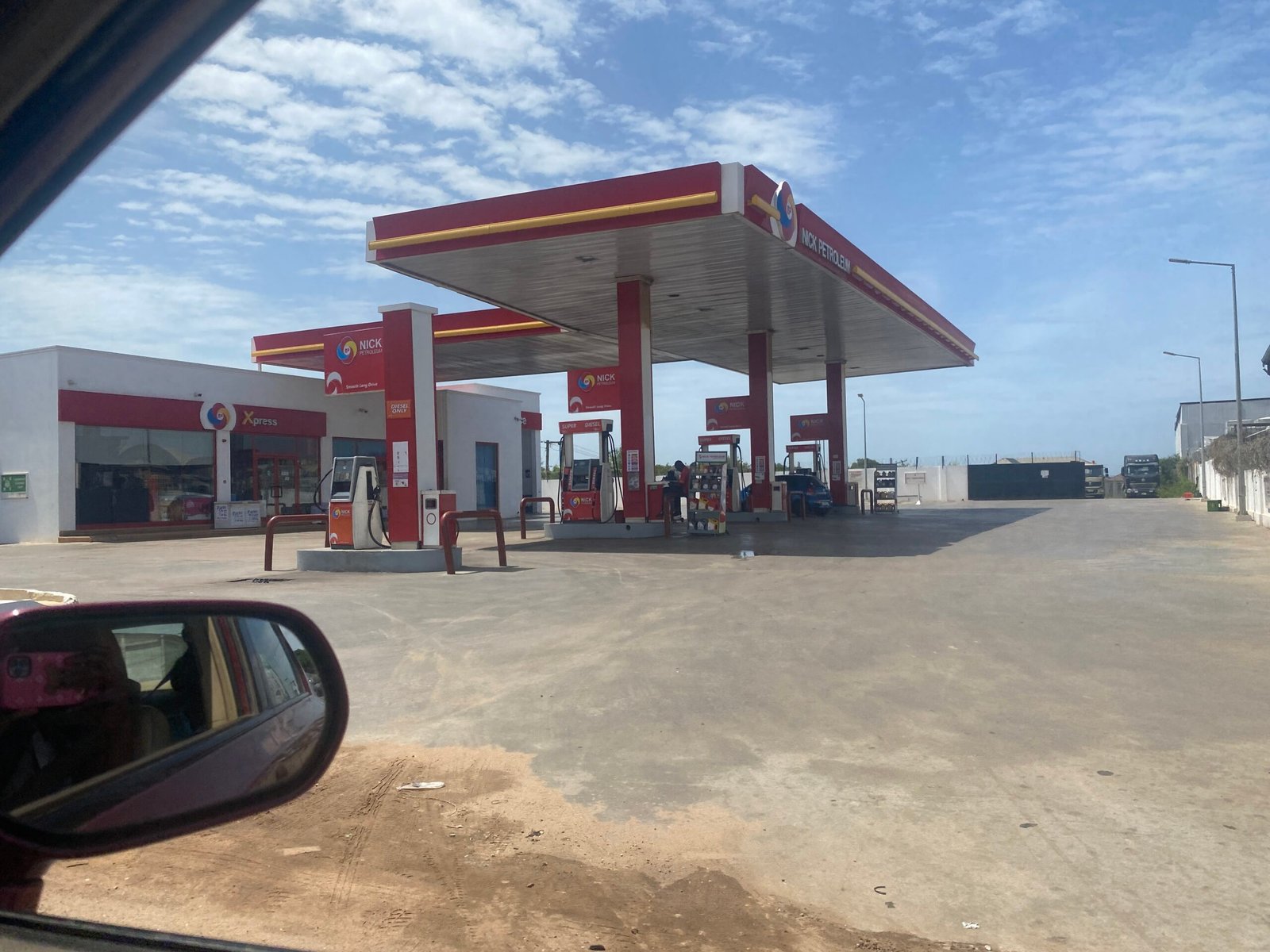 A close-up of a digital fuel pump display showing the price per litre in Ghana