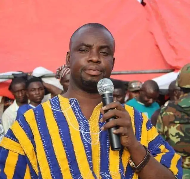 A close-up of a fuel pump nozzle at a gas station