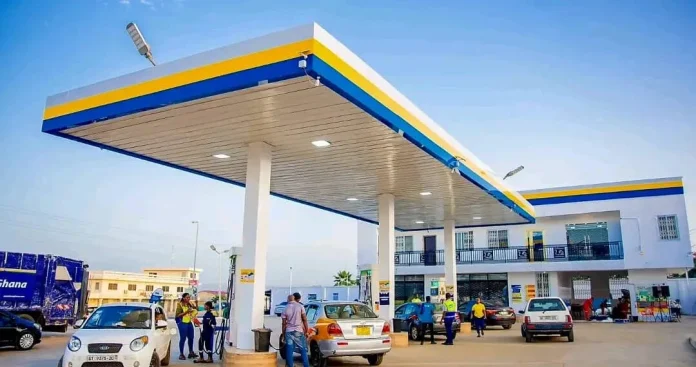 A close-up of a fuel pump nozzle at a gas station